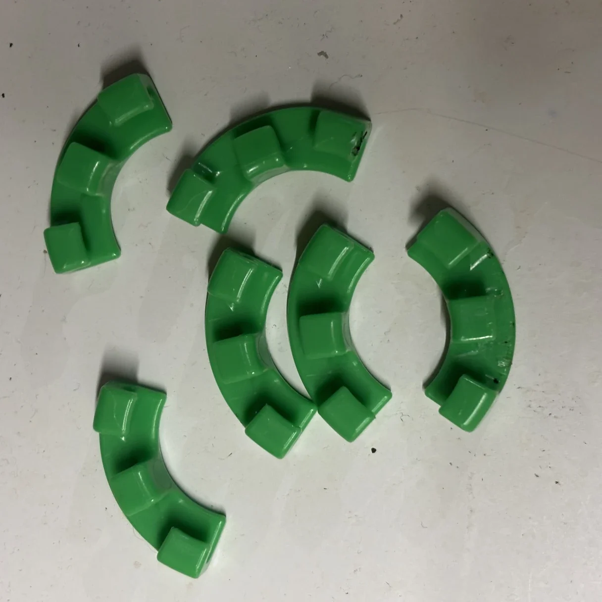 A set of free green LST clips included with a Lighthouse Genetics cannabis seed order