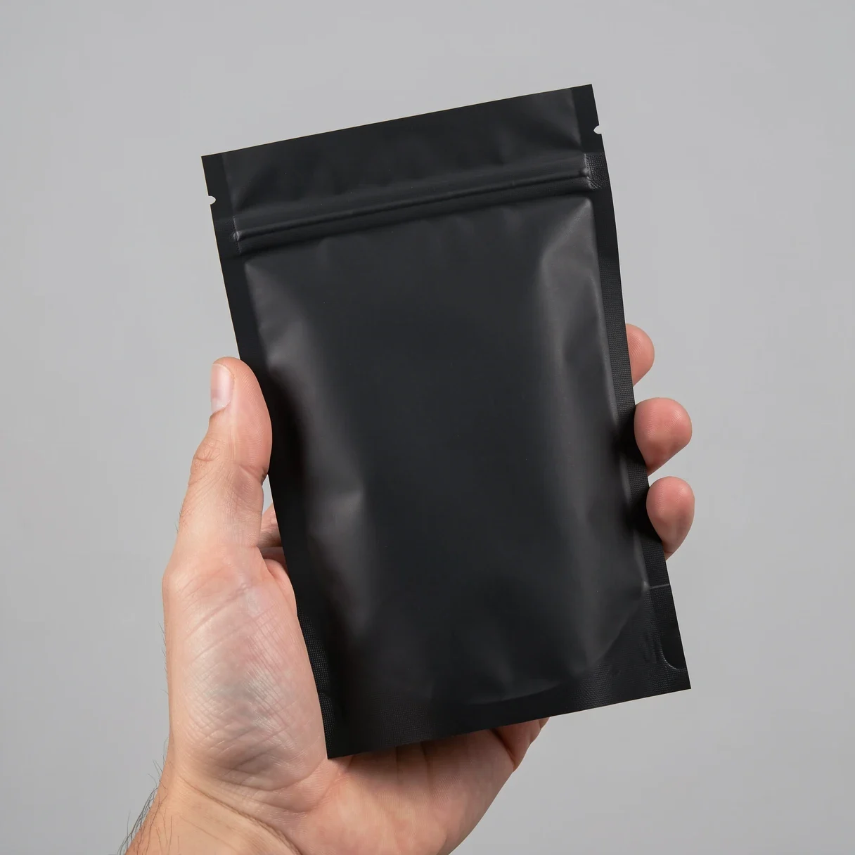 A Lighthouse Genetics feminized cannabis seed pack held in hand
